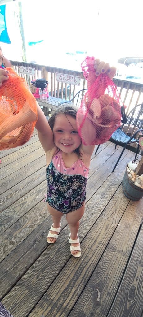 Little girl showing off her seashells from her boat trip in Panama City with Anchor Charters